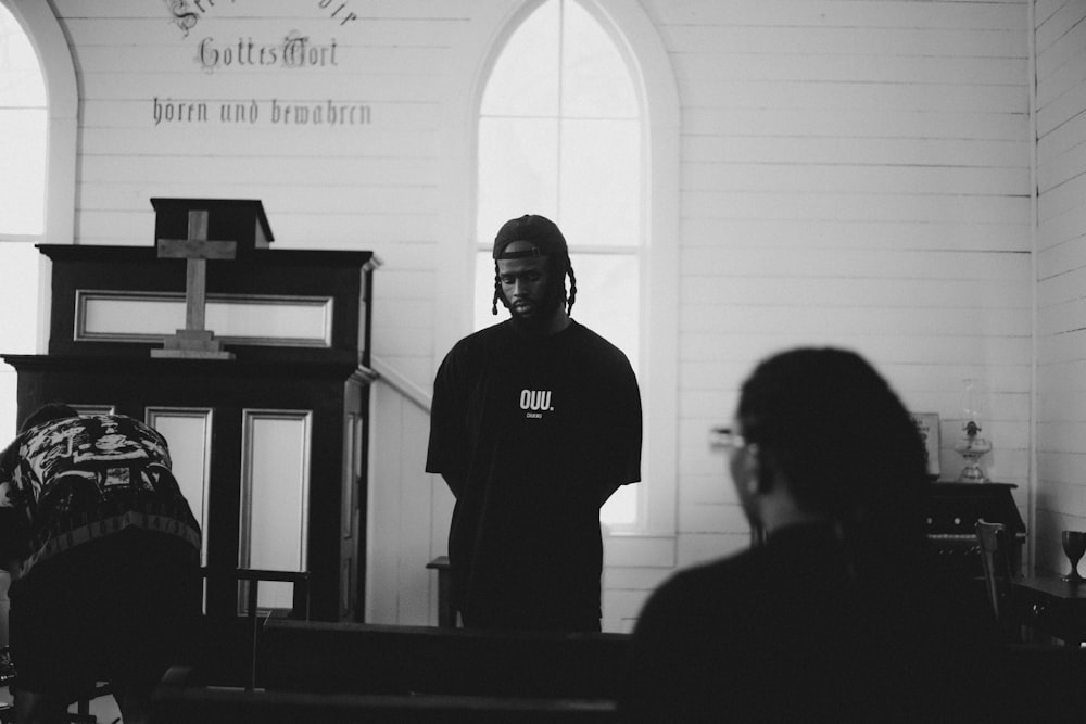 a black and white photo of a man in a church