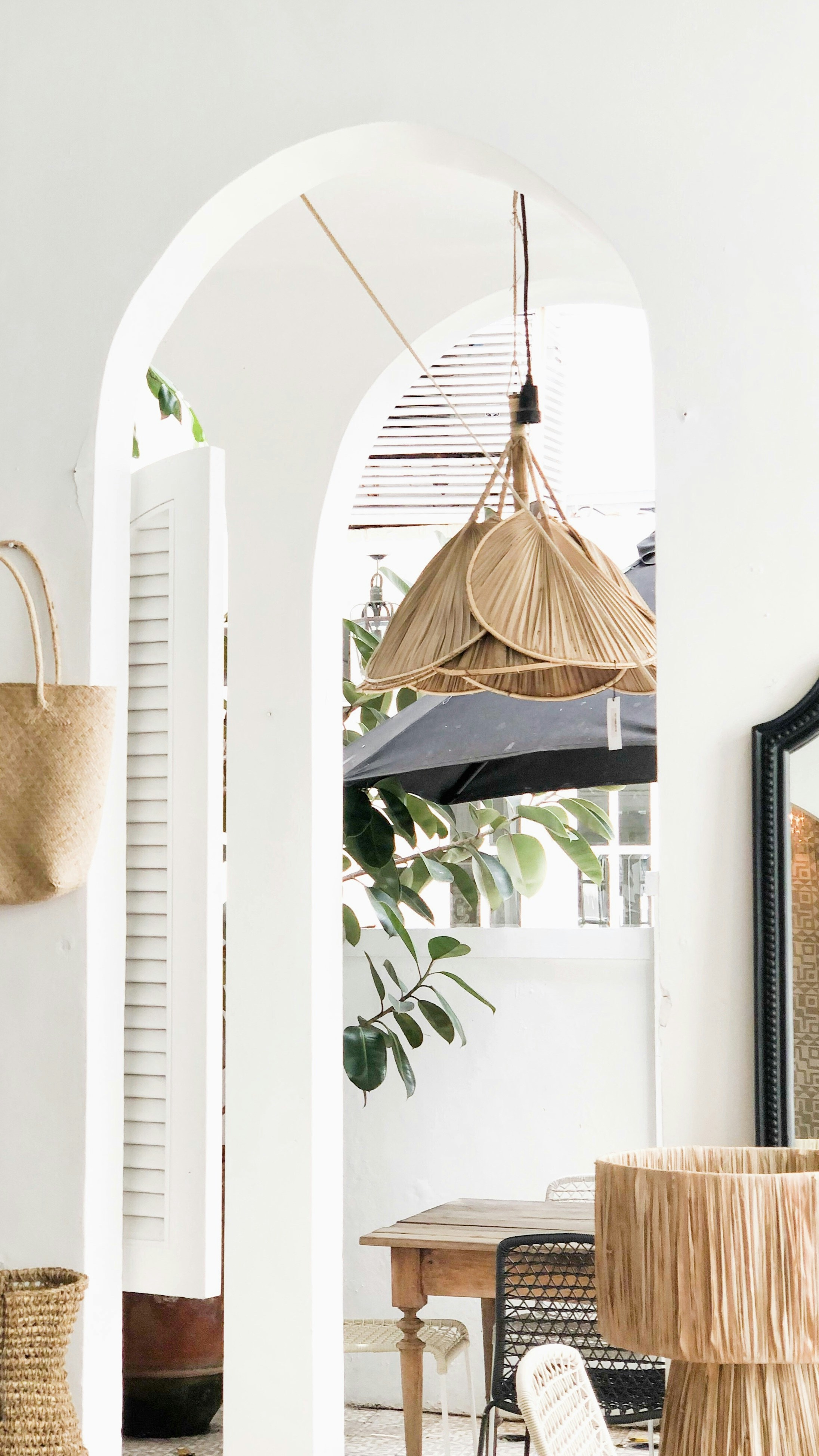 a room with a chair, table and umbrella