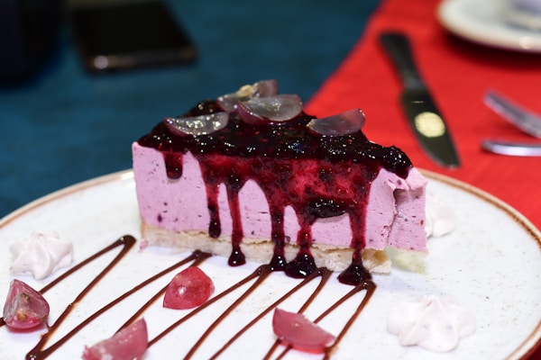 A piece of cheesecake with blueberry topping on a plate