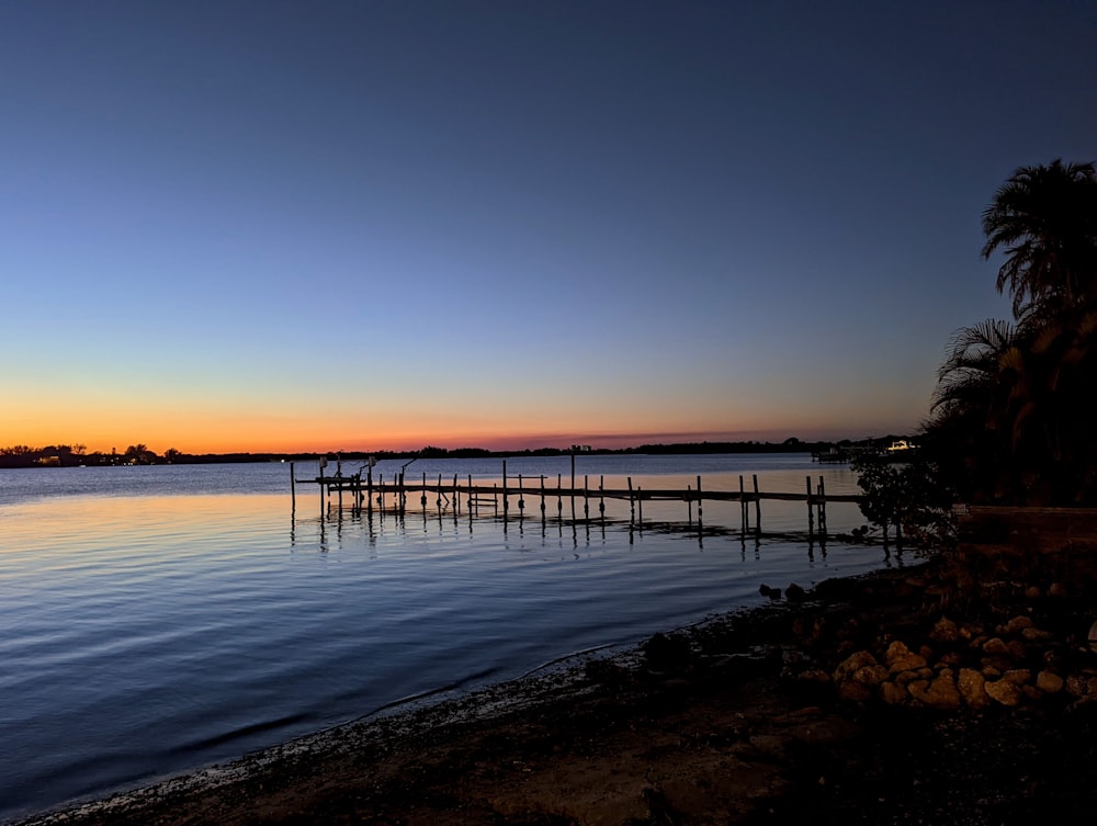 a body of water with a dock in the middle of it