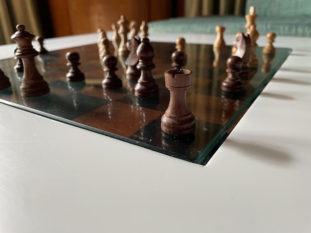 a glass chess board with chess pieces on it
