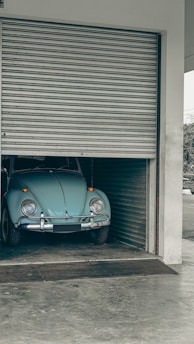 a blue car is parked in a garage