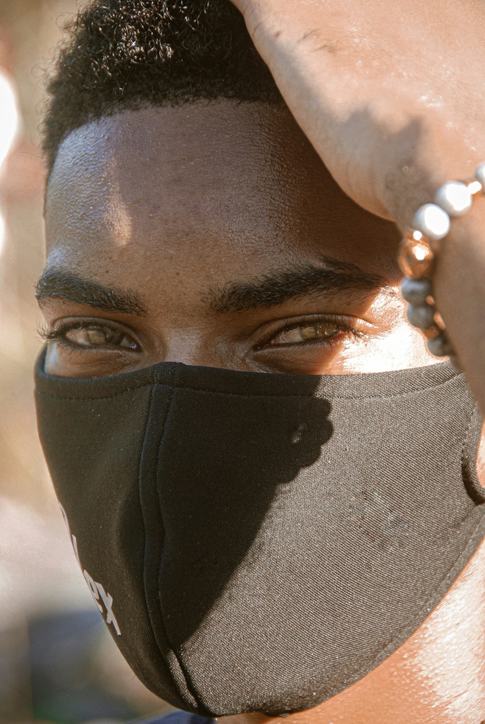 a close up of a person wearing a face mask