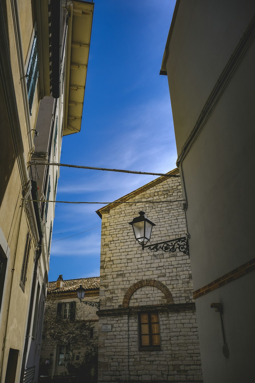 a street light hanging from a wire next to a building