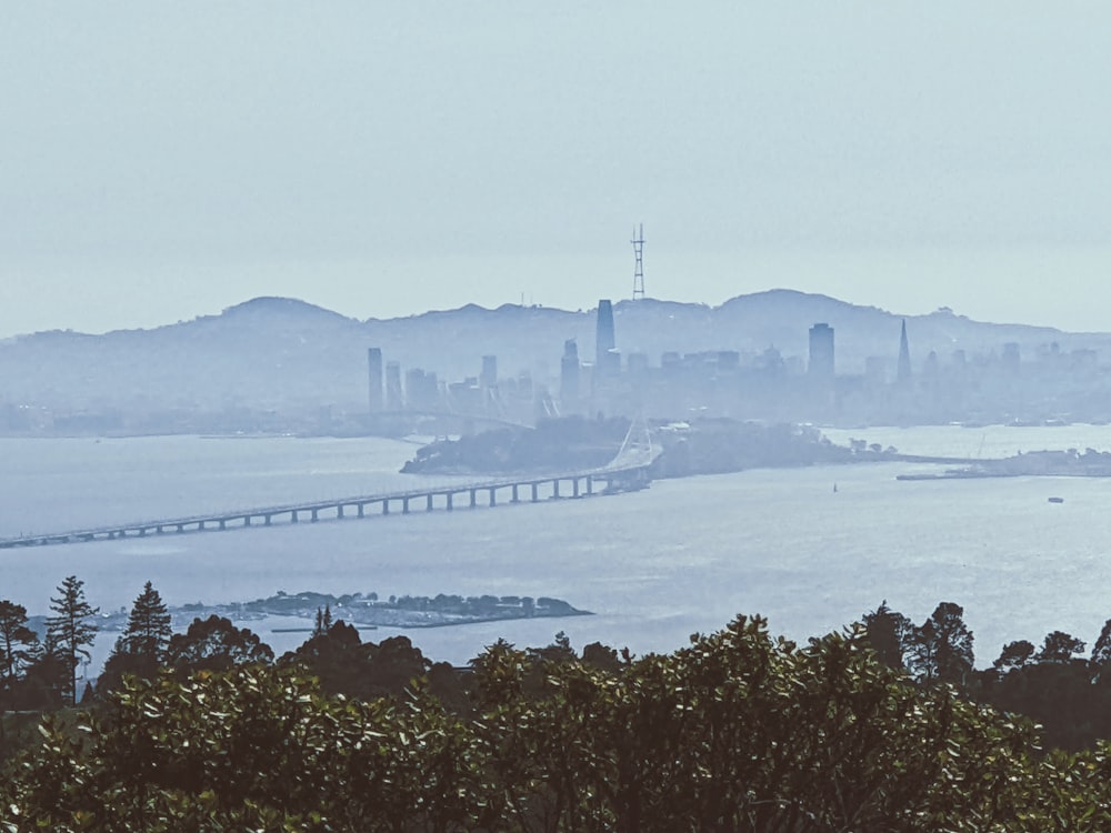 a large body of water with a bridge in the background