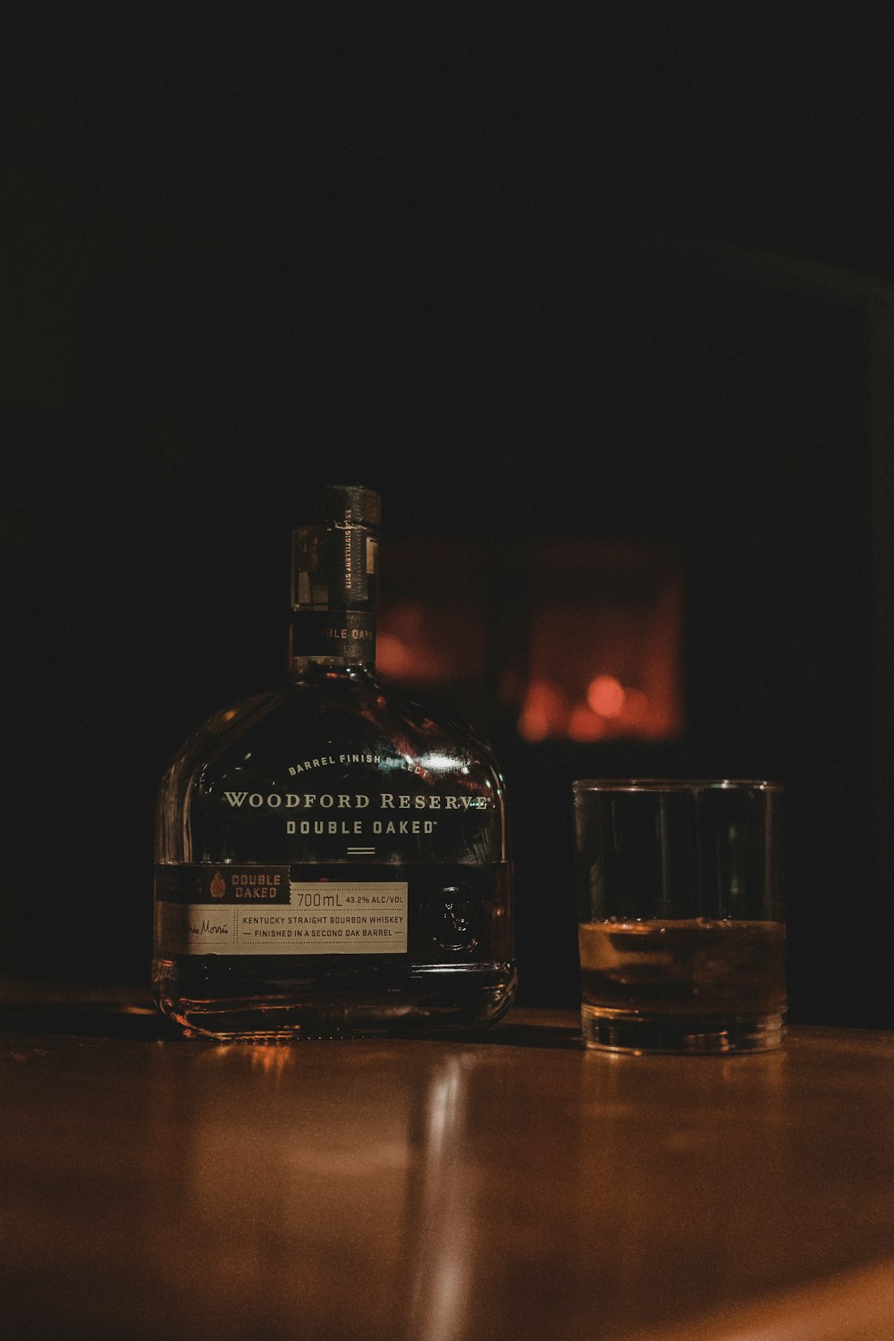 a bottle of whiskey sitting on top of a wooden table