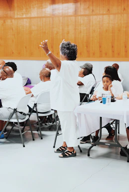 Ethel Moore-Barksdale warmly engaging with a small group during a community faith event on the west side of Chicago.