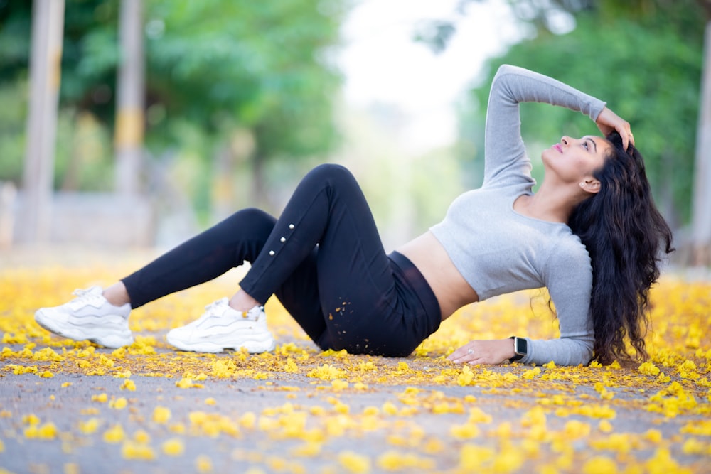 a woman laying on the ground in a park