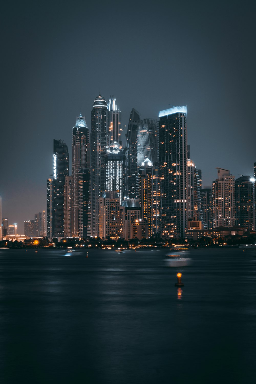 a large body of water with a city in the background