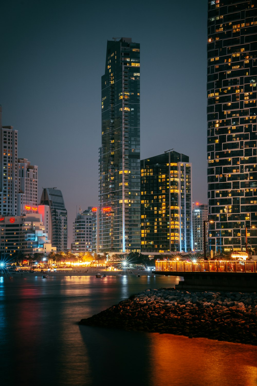 a close up of a bridge over water with a city in the background