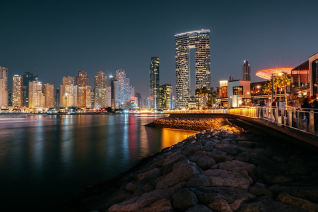 a bridge over a body of water with a city in the background