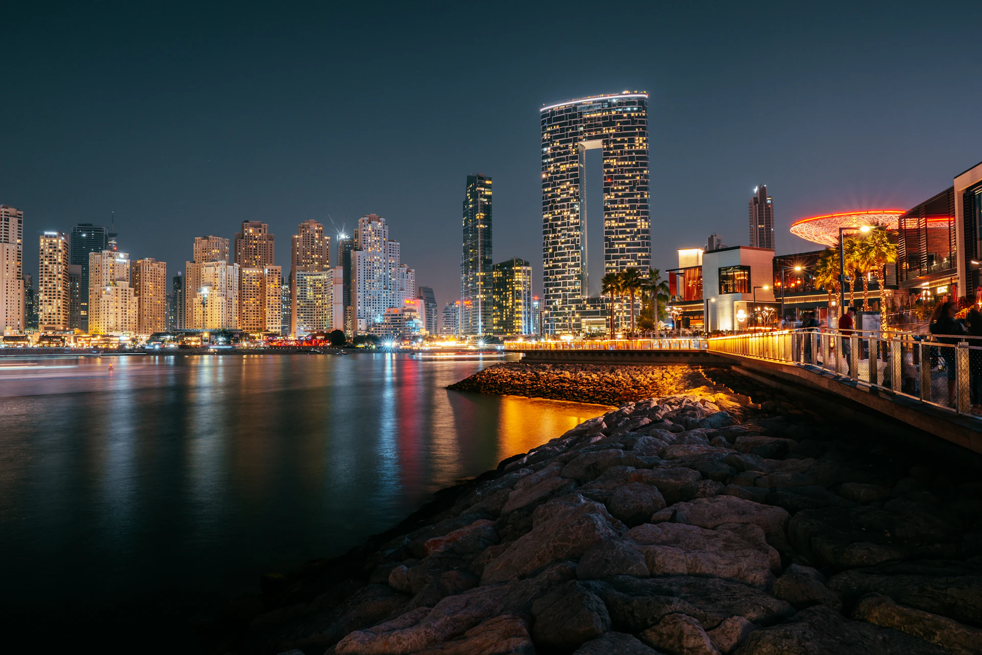 A bridge over the water with the city skyline behind