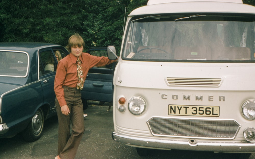 a woman standing next to a parked van