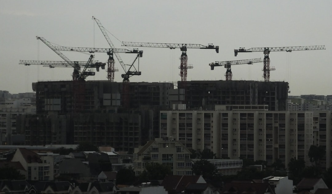 a group of cranes that are on top of a building, Construction Cranes