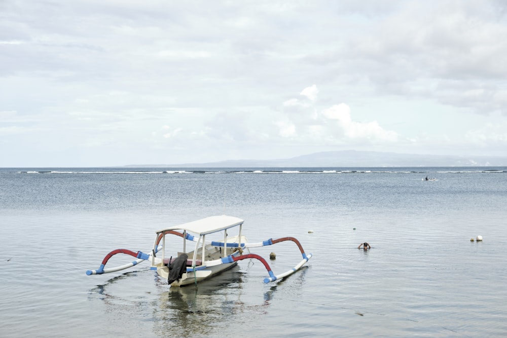 a small boat in the middle of the ocean