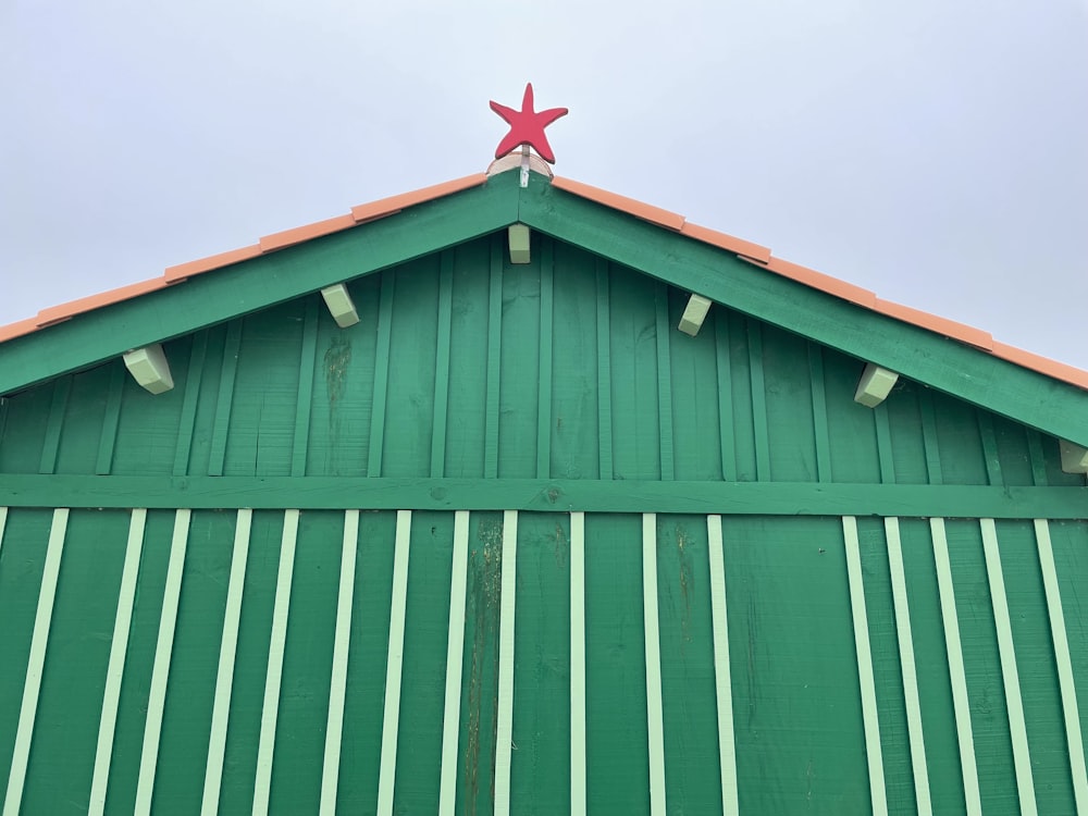 a green building with a red star on top