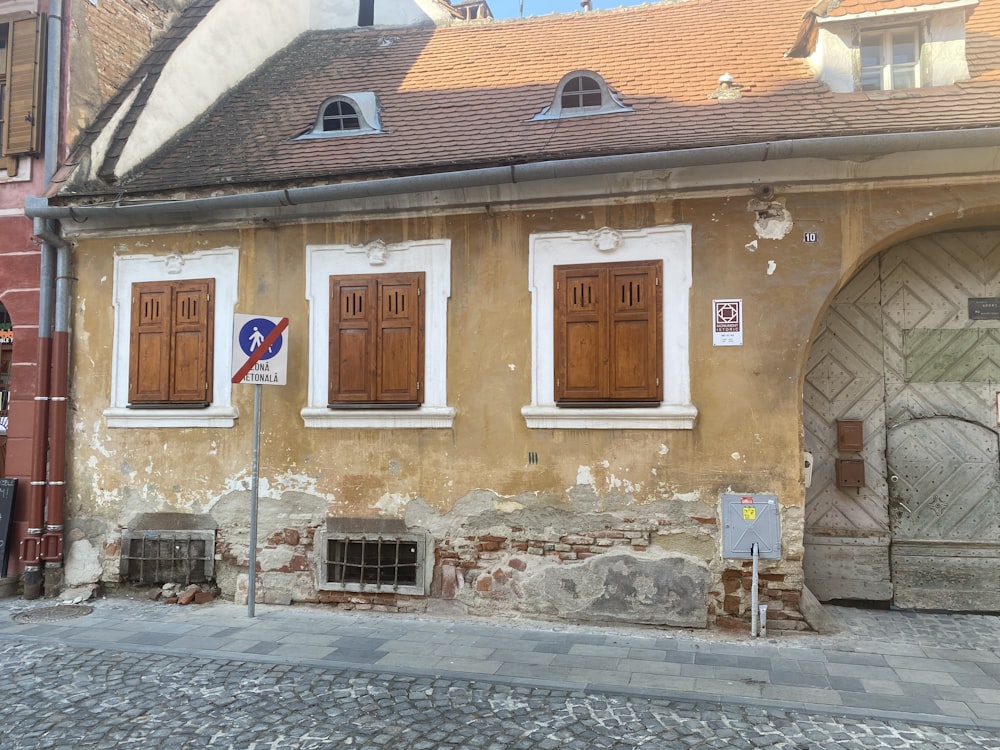 an old building with wooden doors and windows