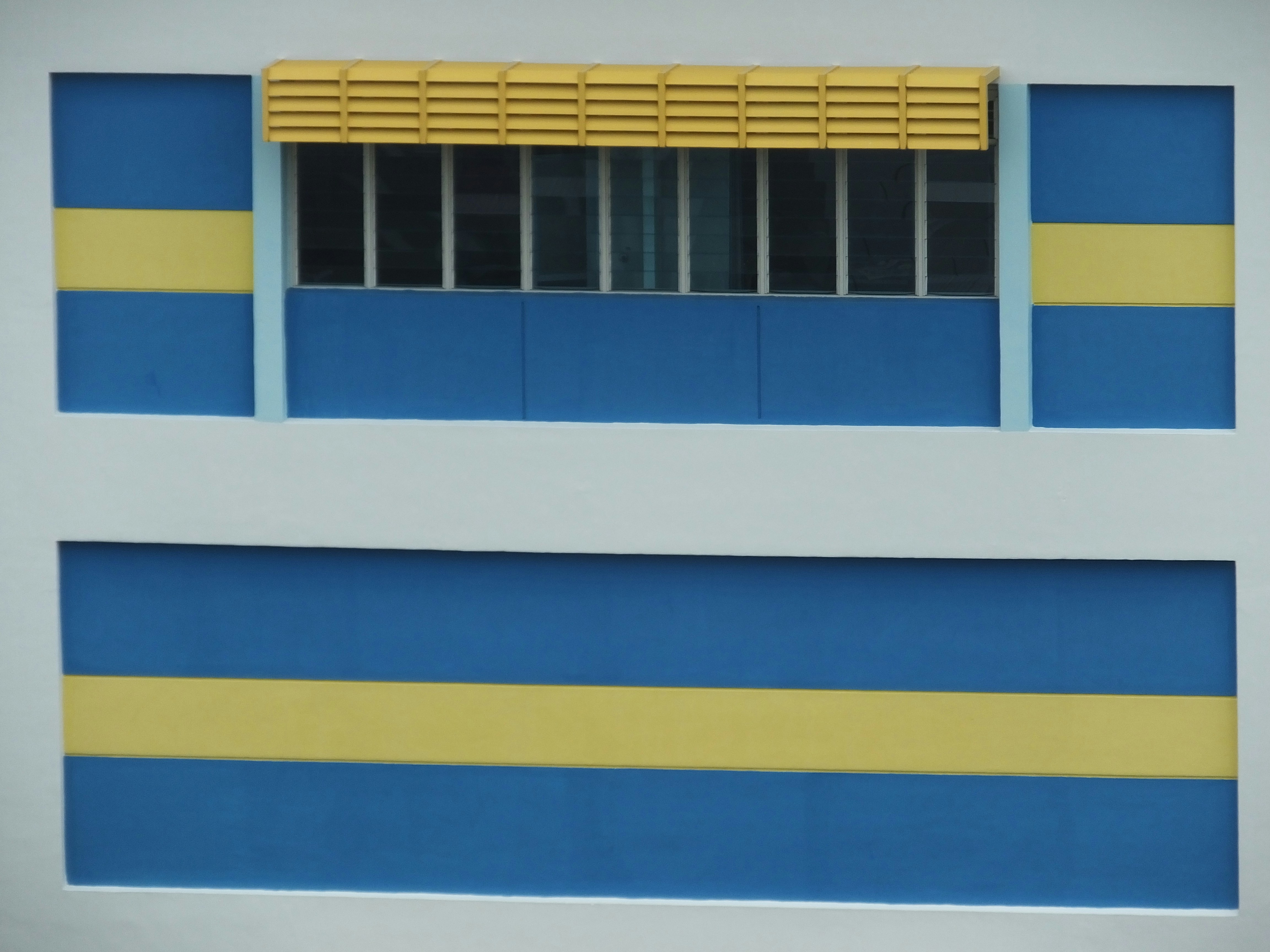 a blue and yellow building with a window