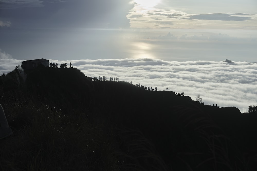 a group of people standing on top of a mountain