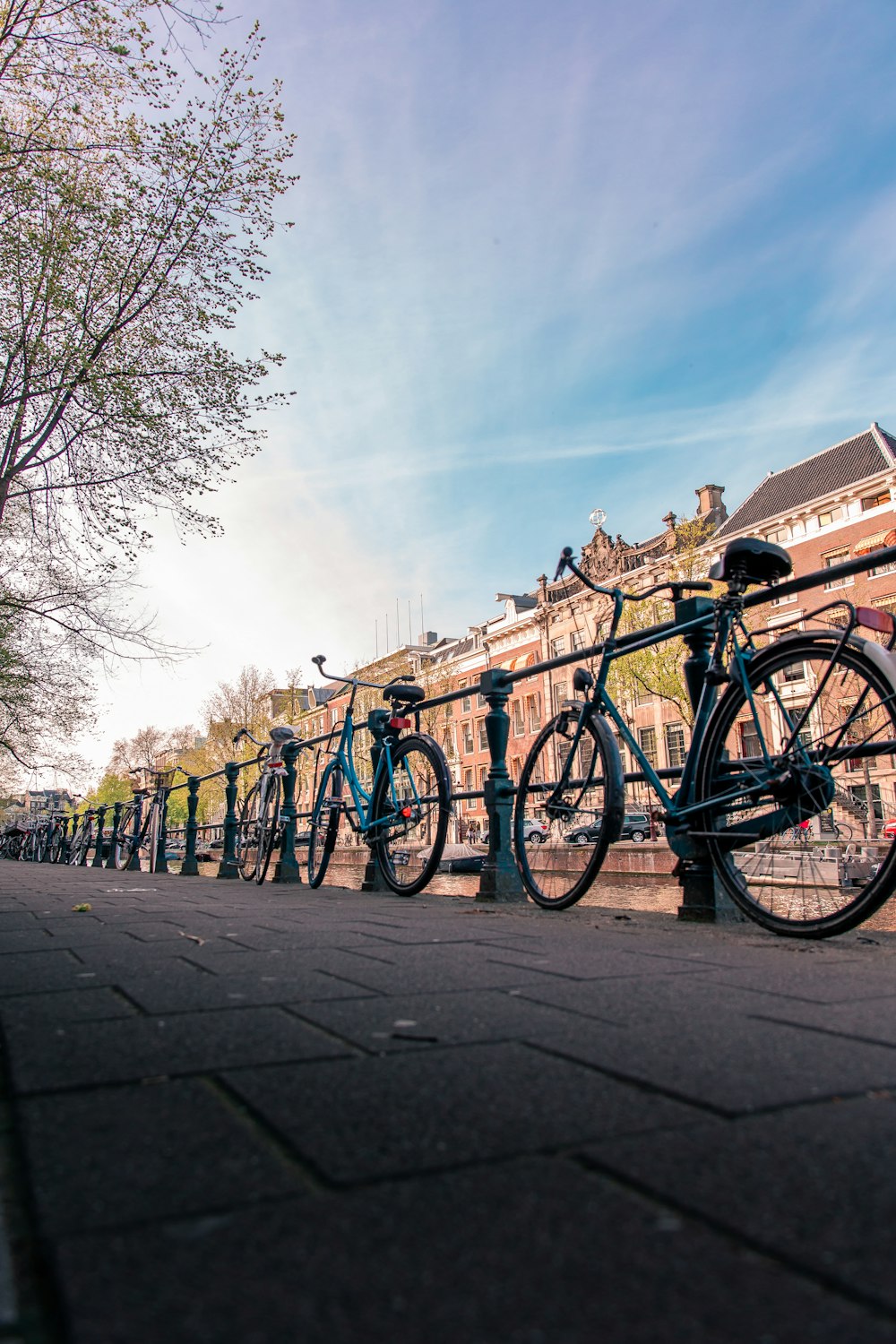 a row of bikes parked next to each other on a sidewalk