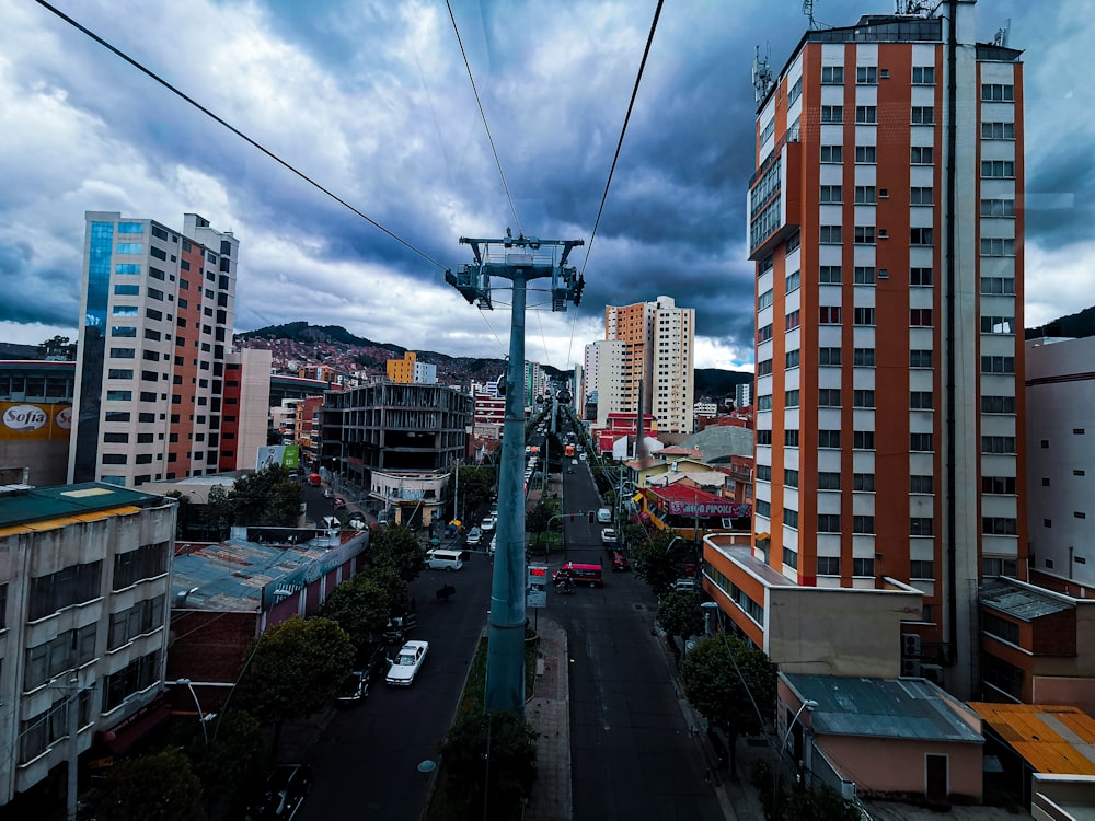 a view of a city street with a cable car going over it