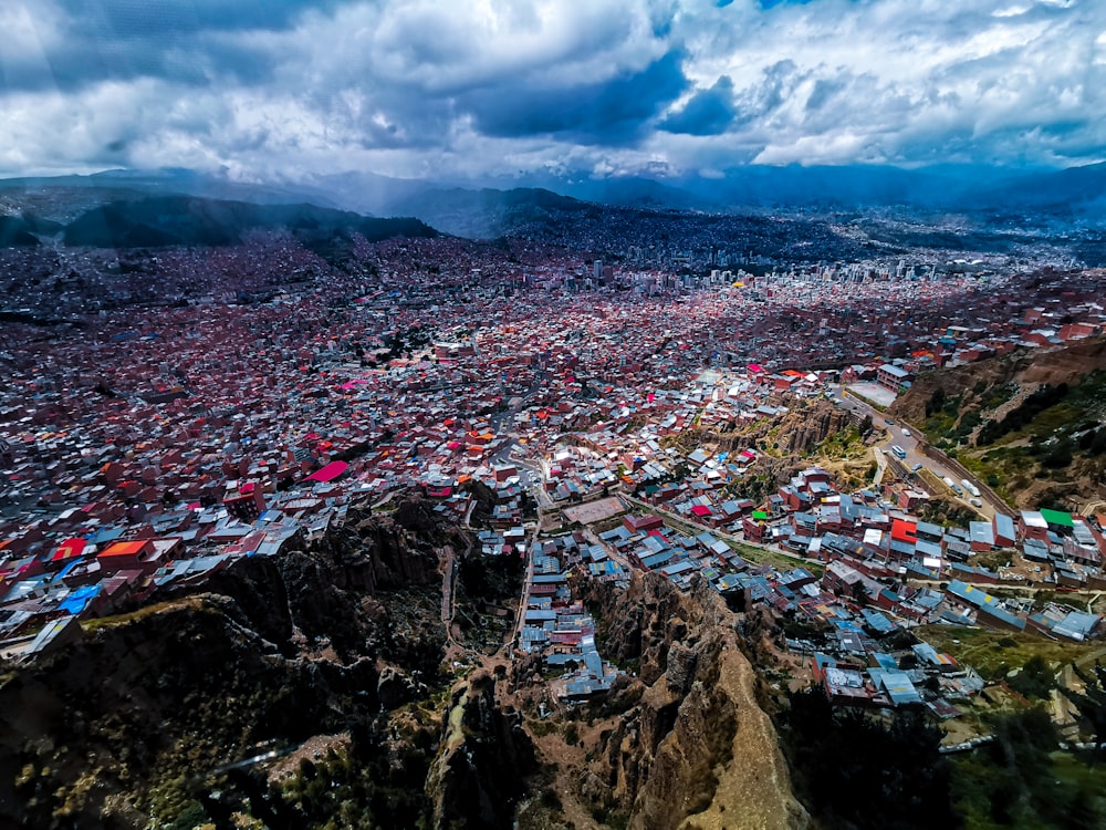 an aerial view of a city with mountains in the background