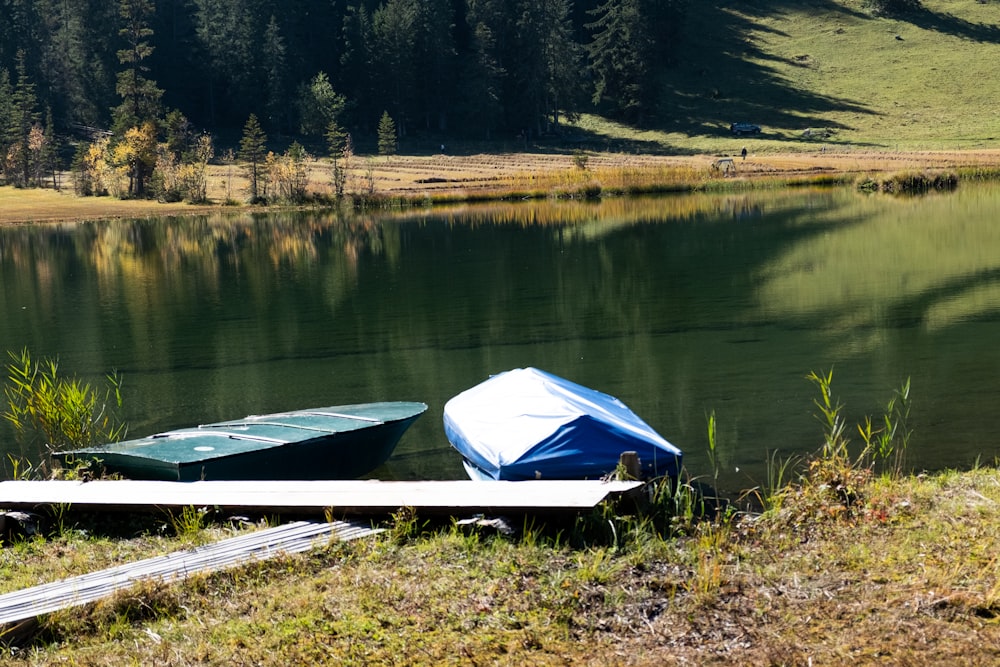 a couple of boats sitting on top of a lake