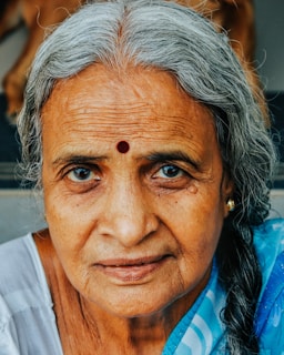 a woman with grey hair and a blue shirt