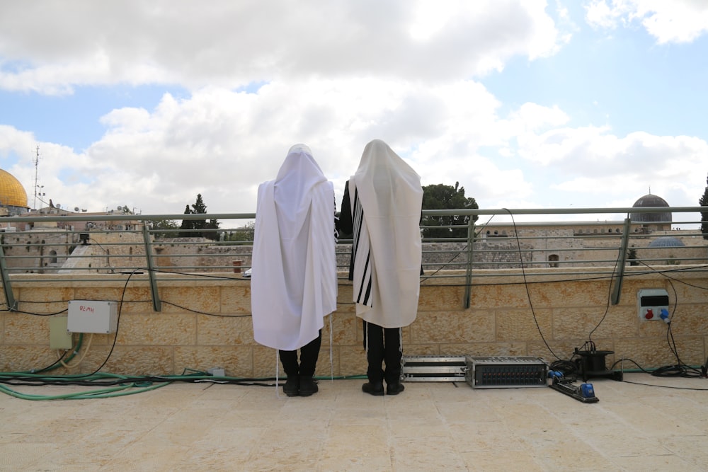 a couple of people standing on top of a roof