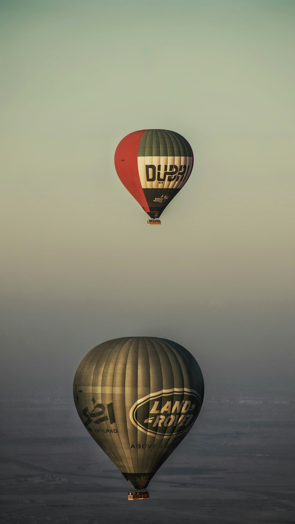 two hot air balloons flying in the sky