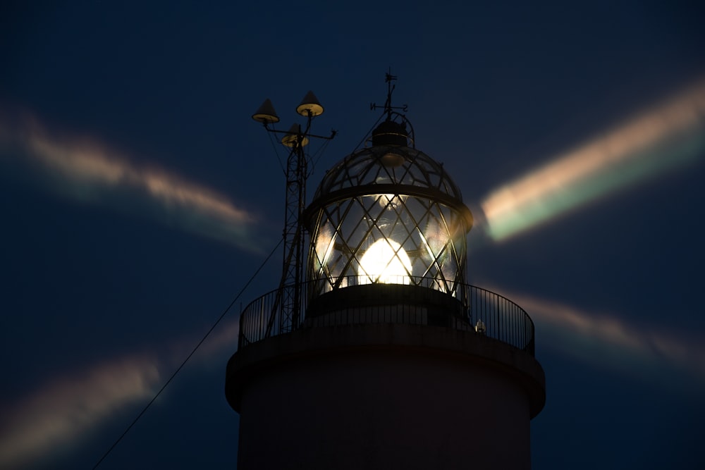 a lighthouse with a light shining on top of it