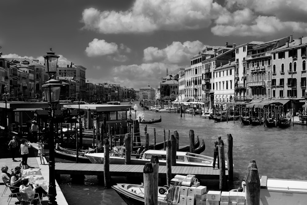 a black and white photo of a waterway with boats