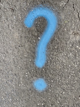 a blue question mark painted on the ground
