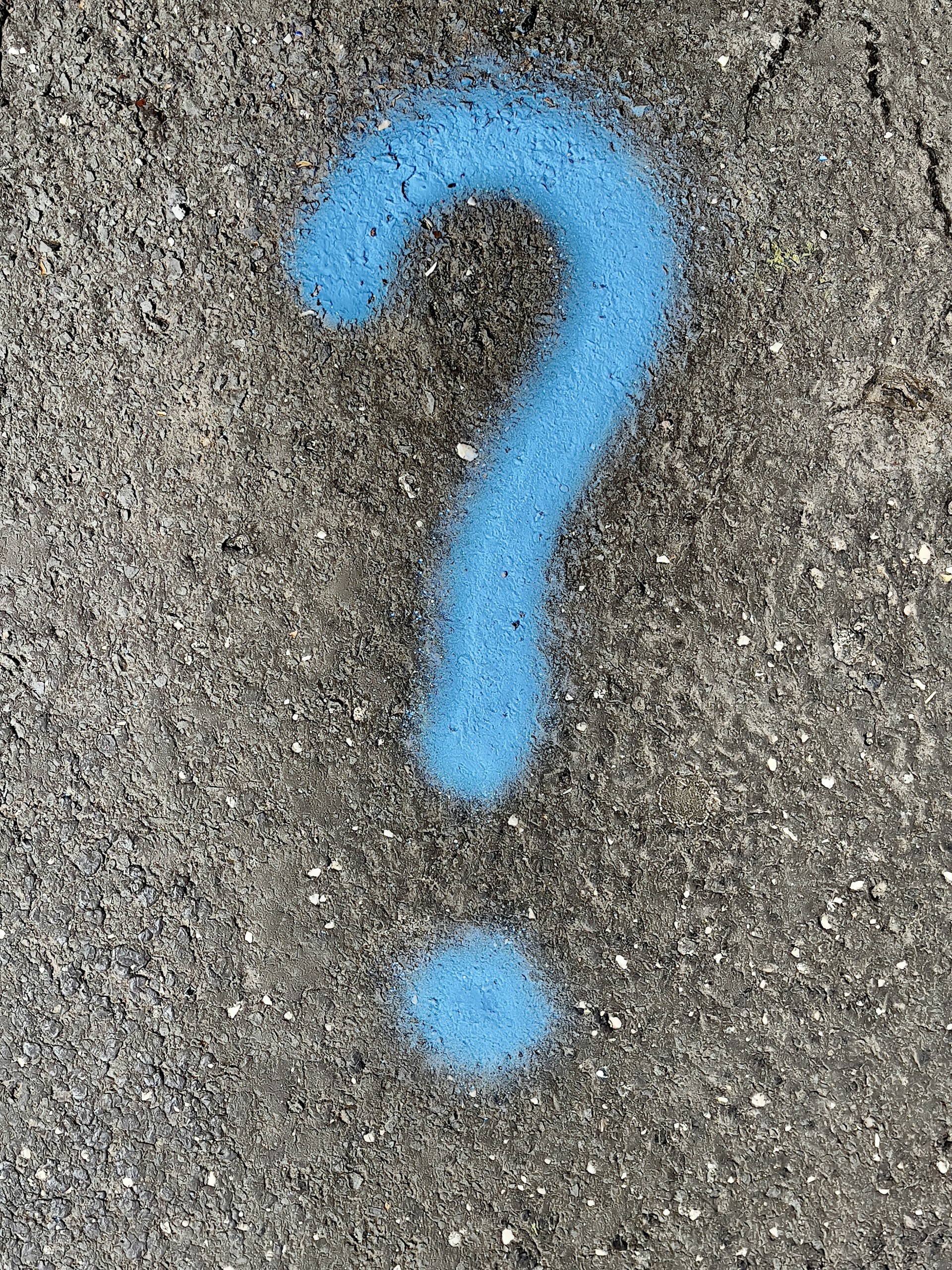 a blue question mark painted on the ground