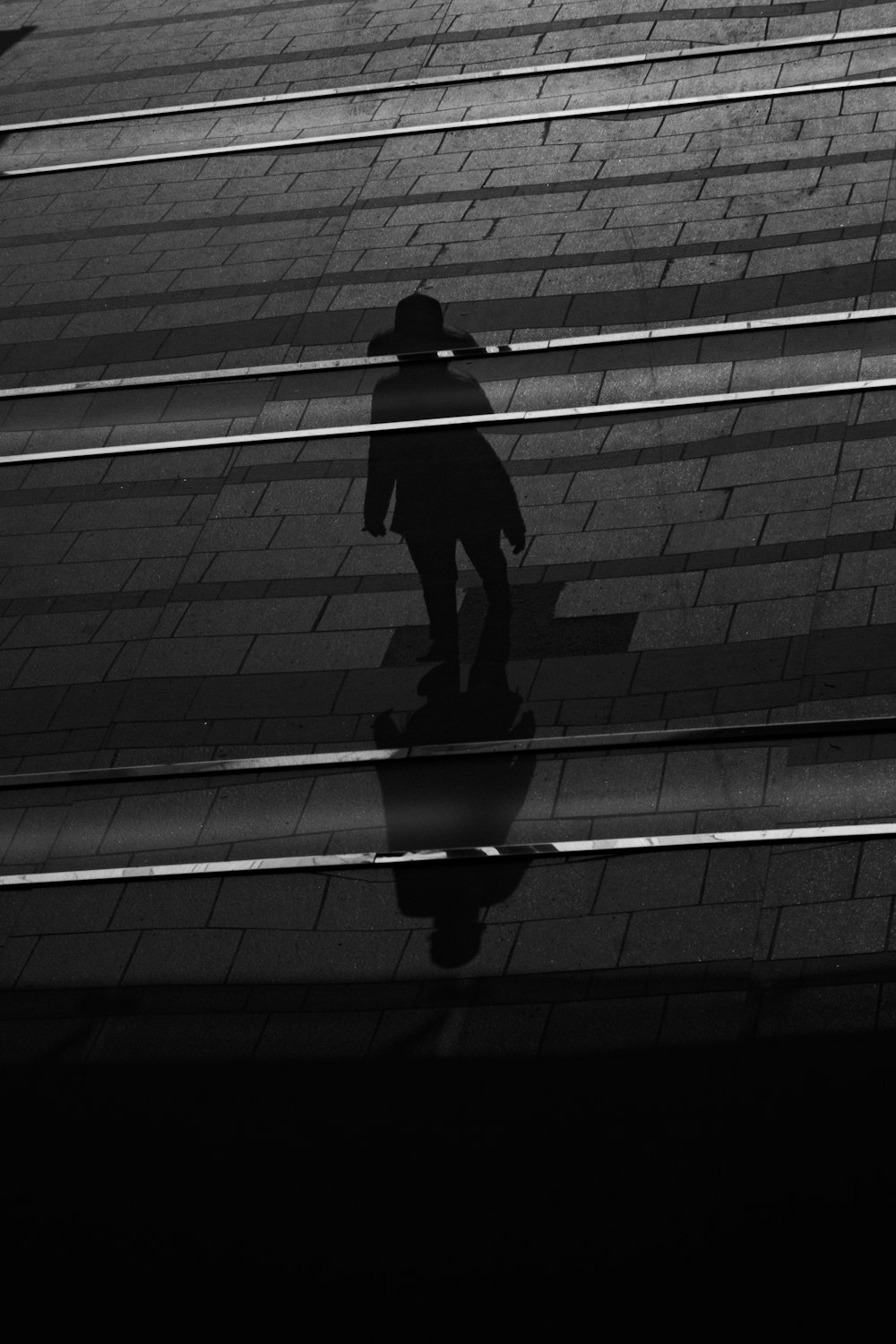 a black and white photo of a person on a skateboard