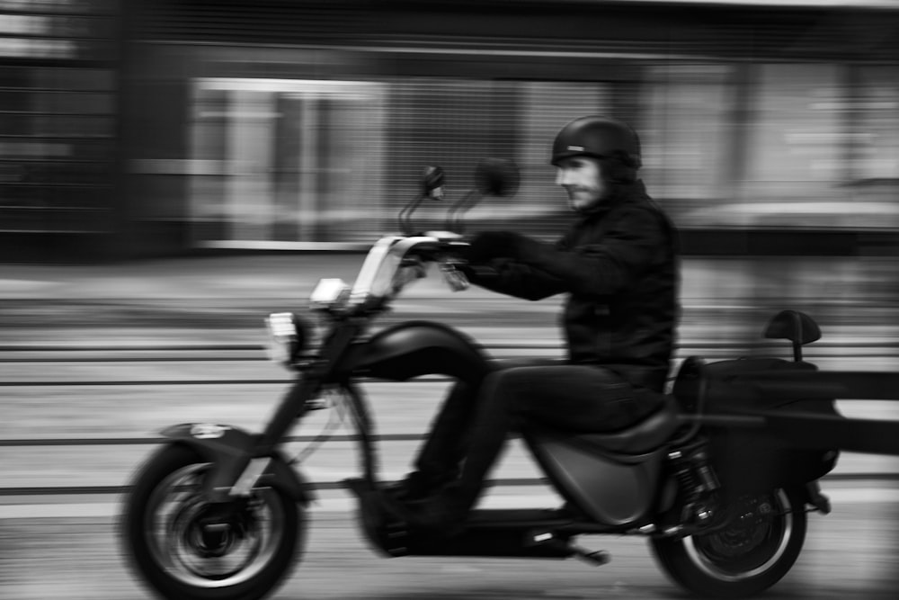 a man riding a motorcycle down a street