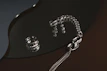 A collection of bold statement rings and bracelets artfully arranged on a mirrored surface.