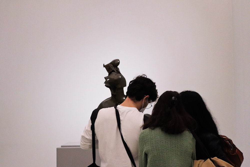 two people looking at a sculpture in a museum