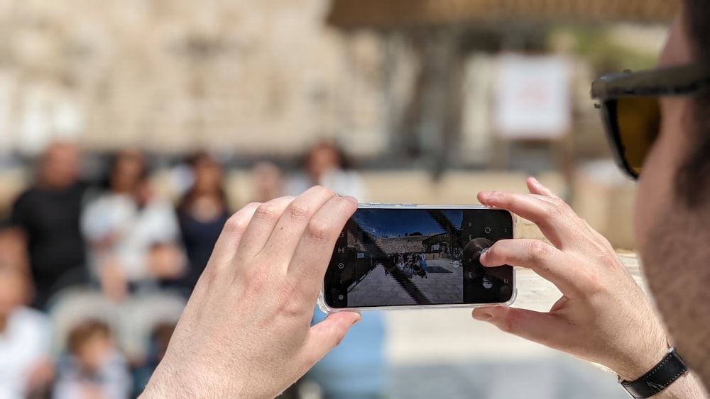 a man taking a picture with his cell phone