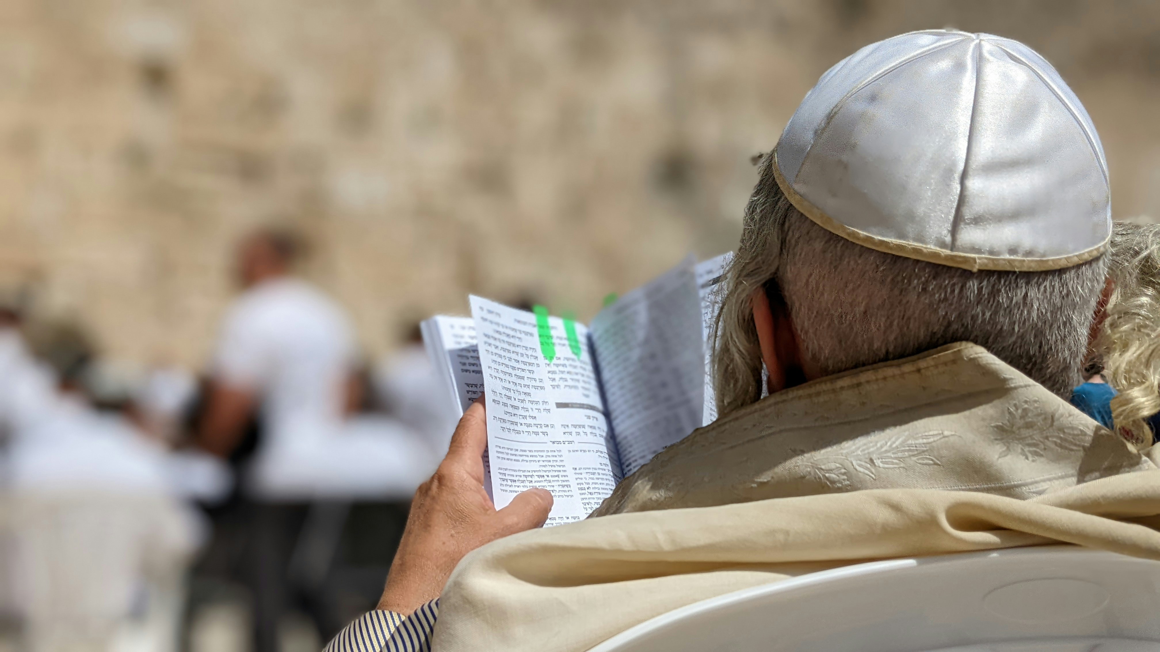 a man sitting in a chair reading a paper