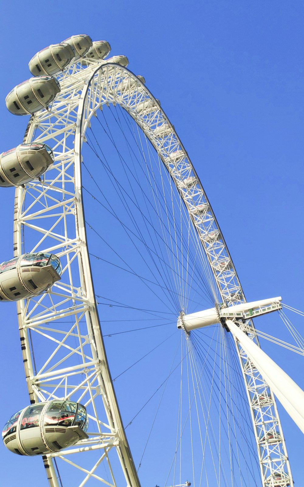 a large white ferris wheel against a blue sky