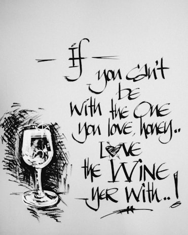 Calligraphic text with a playful quote about wine, accompanied by an artistic sketch of a wine glass.