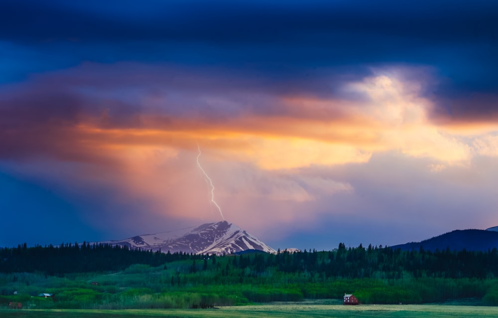 a mountain with a lightning bolt in the sky