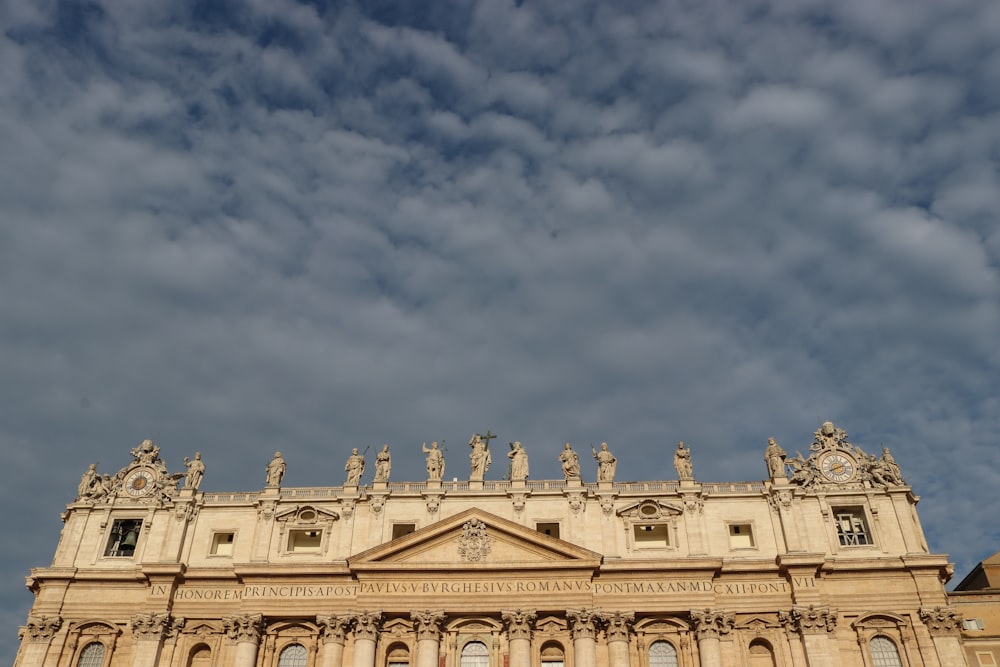 a large building with statues on top of it