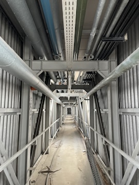 Long industrial cable tray installed along a factory wall.