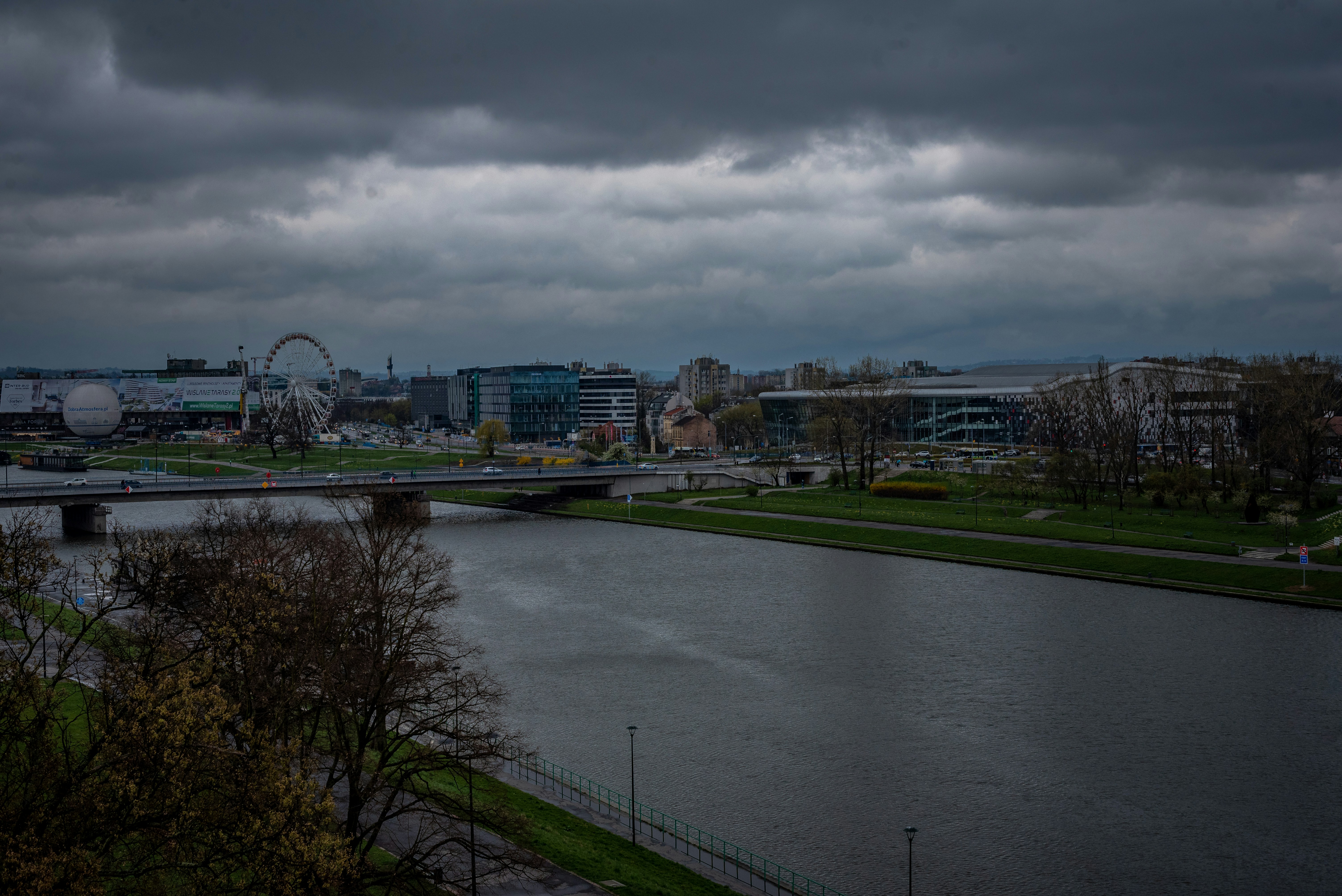 A river running through a city under a cloudy sky photo – Free Grey ...