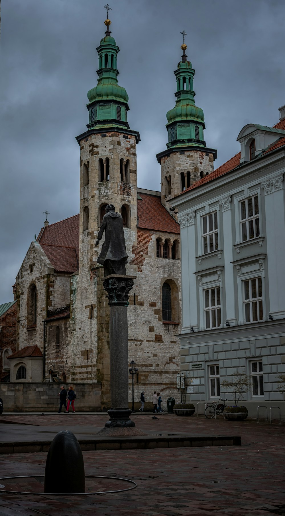 a large building with two towers and a statue in front of it