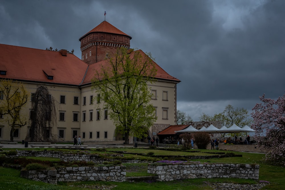 a large building with a red roof and a clock tower