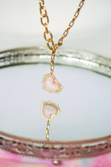a close up of a necklace on a table