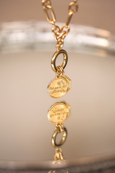 a close up of a gold necklace on a plate
